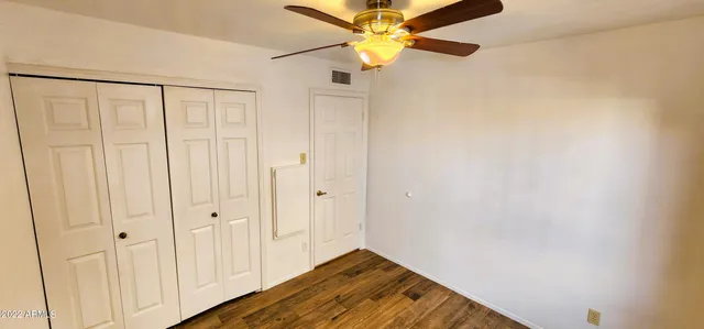 a view of a hallway with a chandelier fan