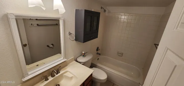 a bathroom with a sink a toilet a mirror and shower