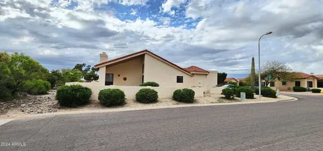 a view of a house with wooden fence