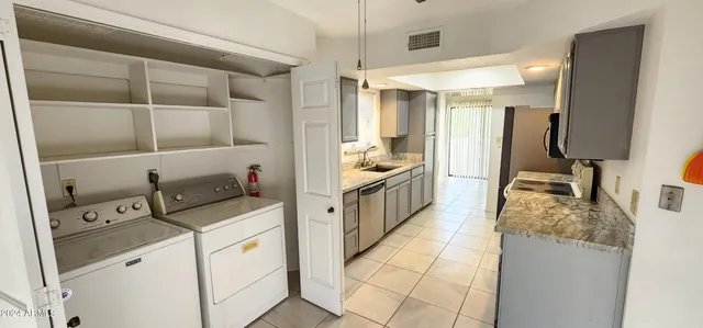 a kitchen with a sink appliances and cabinets