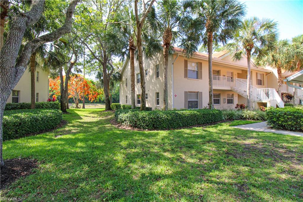 225 Robin Hood Circle, Unit 203 Naples, FL 34104 - Photo 2 of 50 View of nearby features with a yard