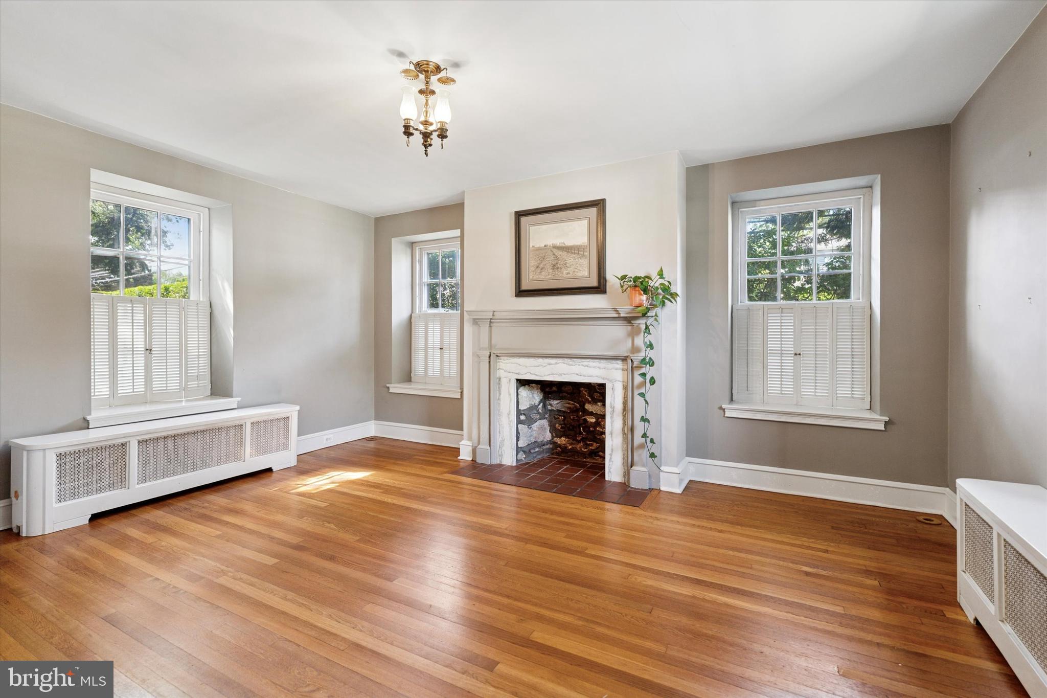 301 East Moreland Road Willow Grove, PA 19090 - Photo 3 of 21 a view of empty room with wooden floor and fireplace