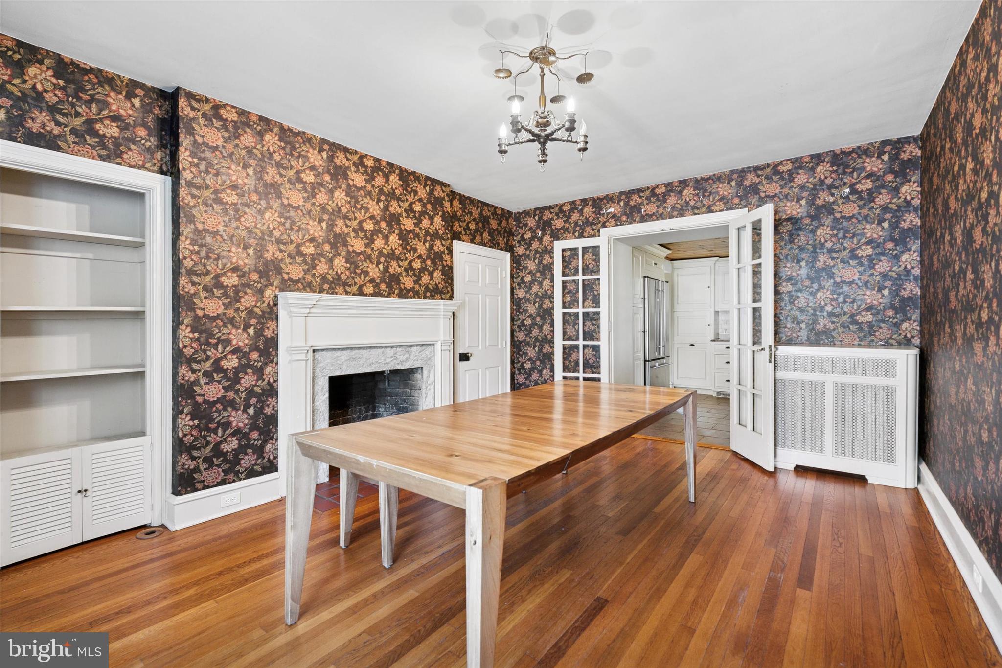 301 East Moreland Road Willow Grove, PA 19090 - Photo 4 of 21 a dining room with wooden floor a chandelier a wooden table and chairs