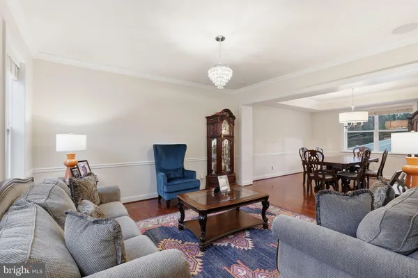a view of a livingroom with a chandelier fan
