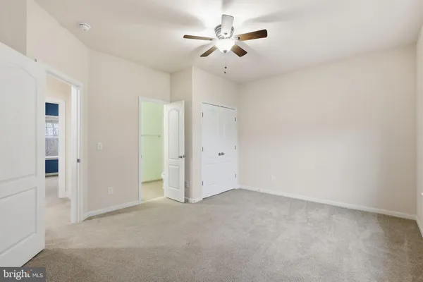 a view of a white house with a big yard and large tree