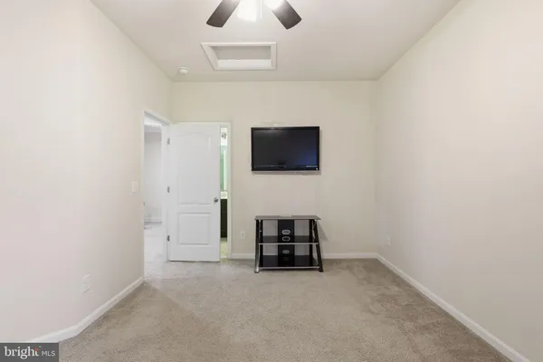 a view of a house with a big yard and large trees