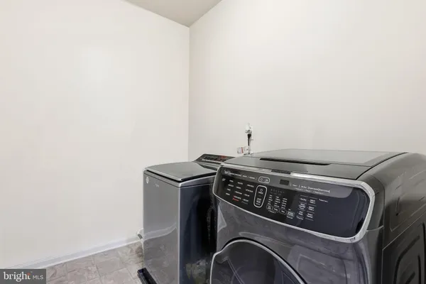 a view of a house with a big yard and large trees