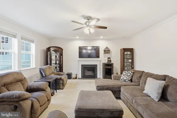 a dining room with furniture a chandelier and wooden floor
