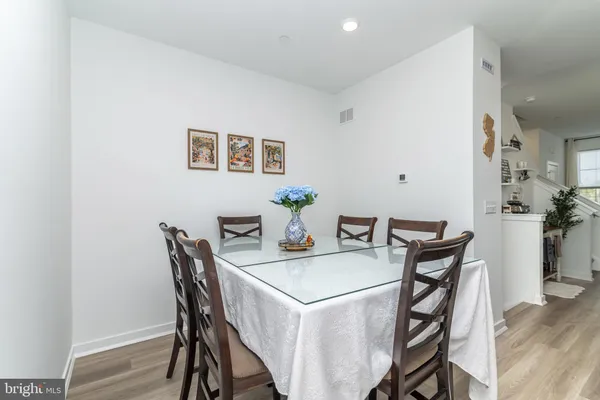 a view of a dining room with furniture and potted plant