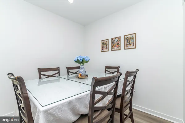 a dining room with furniture and wooden floor