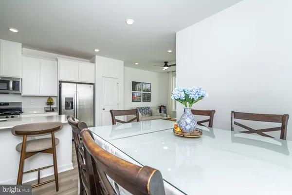 a kitchen with a table chairs and refrigerator