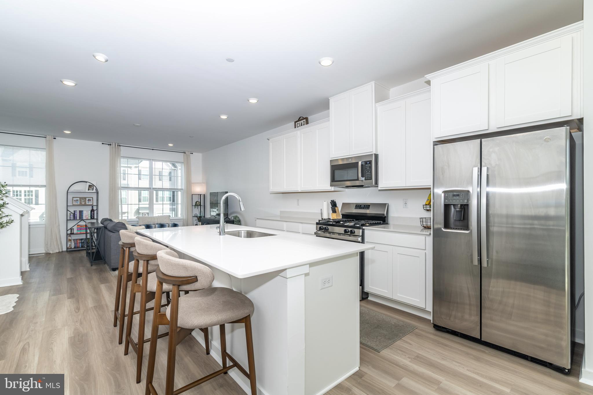 41 Barnes Way Sicklerville, NJ 08081 - Photo 18 of 46 a kitchen with stainless steel appliances a table chairs and a refrigerator