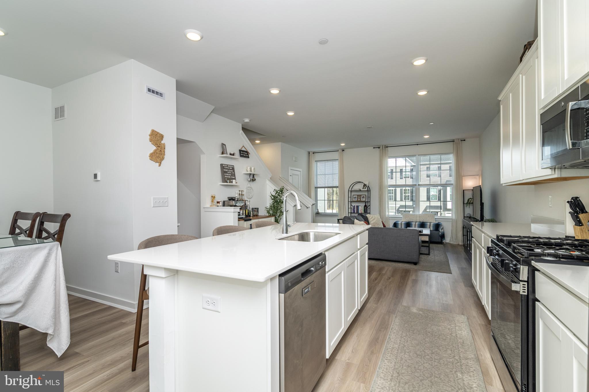 41 Barnes Way Sicklerville, NJ 08081 - Photo 19 of 46 a large white kitchen with a stove a sink a refrigerator and cabinets
