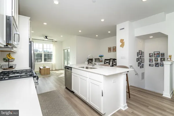 a kitchen with a sink stove and refrigerator
