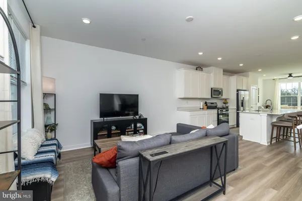 a kitchen with stainless steel appliances granite countertop a sink a stove and a refrigerator