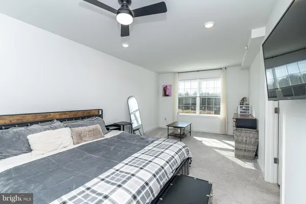 a bedroom with a bed and window