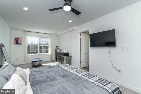 a bedroom with furniture and a flat screen tv