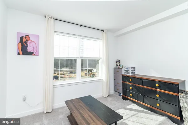 a room with a dresser and a window