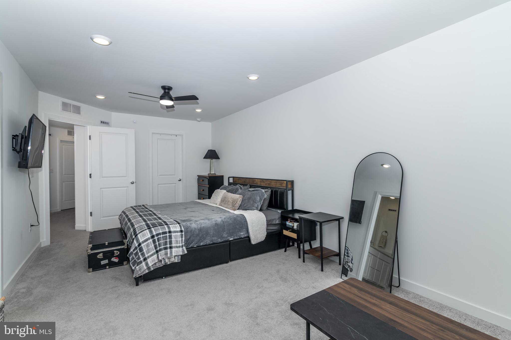 41 Barnes Way Sicklerville, NJ 08081 - Photo 34 of 46 a spacious bedroom with a bed a couch and a chandelier