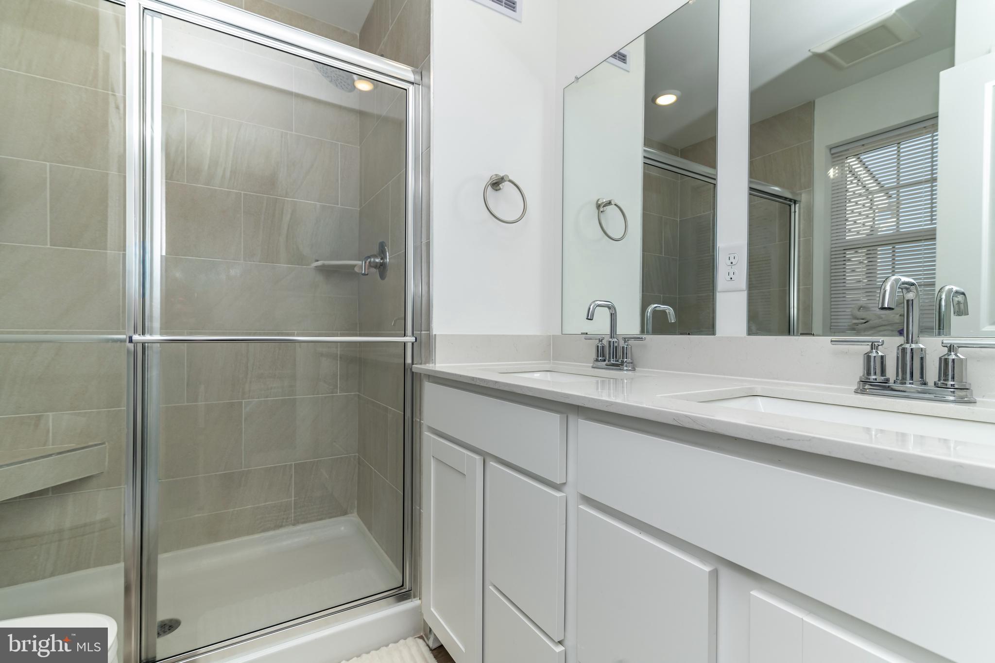 41 Barnes Way Sicklerville, NJ 08081 - Photo 35 of 46 a bathroom with a shower sink and mirror