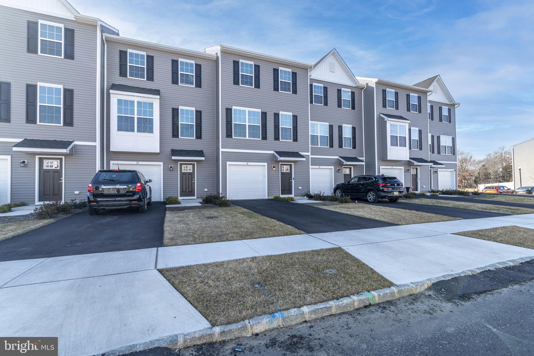 41 Barnes Way Sicklerville, NJ 08081 - Photo 4 of 46 a city street lined with buildings and cars parked on the roadside