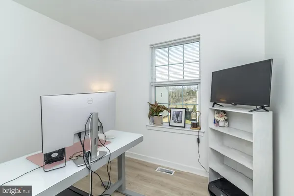 a view of a livingroom with furniture and a window