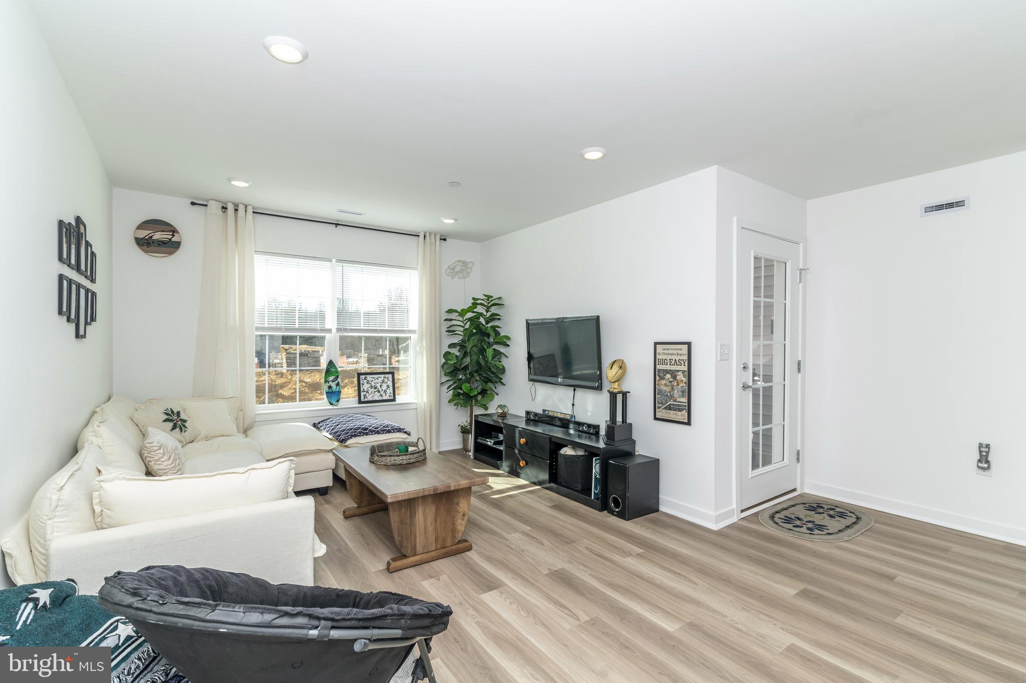 41 Barnes Way Sicklerville, NJ 08081 - Photo 8 of 46 a living room with furniture a fireplace and a flat screen tv