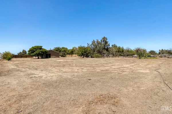a view of a field with trees in the background