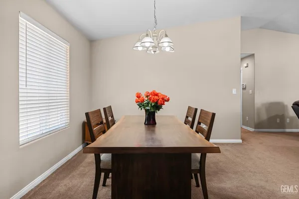 a dining room with furniture and chandelier