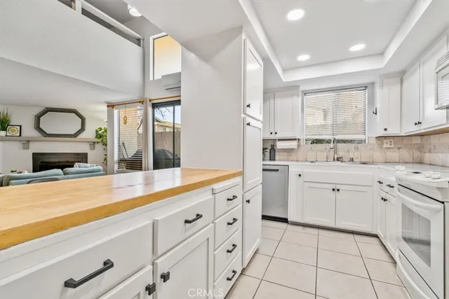 a kitchen with cabinets a sink and appliances