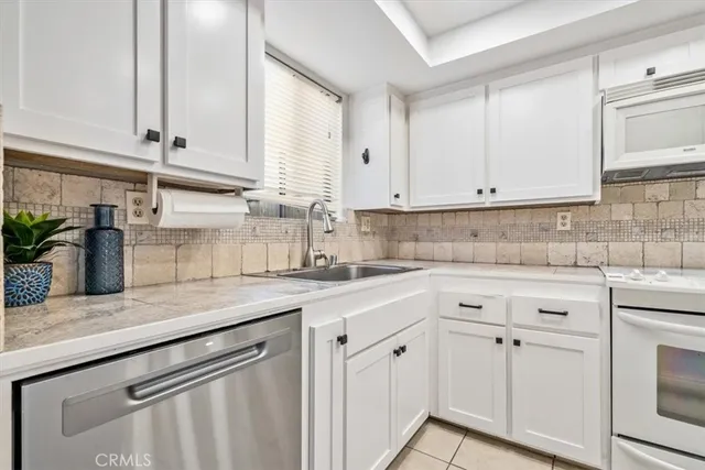 a bathroom with a granite countertop sink toilet and a mirror