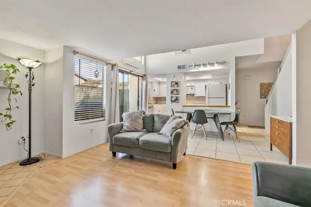 a dining room with furniture and a floor to ceiling window
