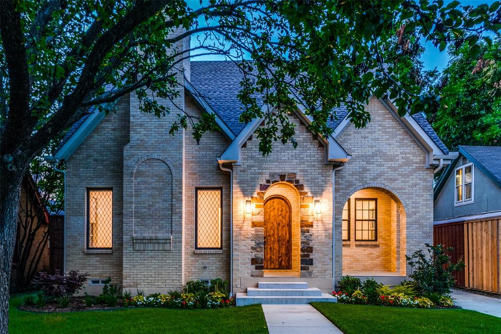 5135 Ridgedale Avenue Dallas, TX 75206 - Photo 1 of 1 a view of a brick house with large windows and a yard with plants and large trees