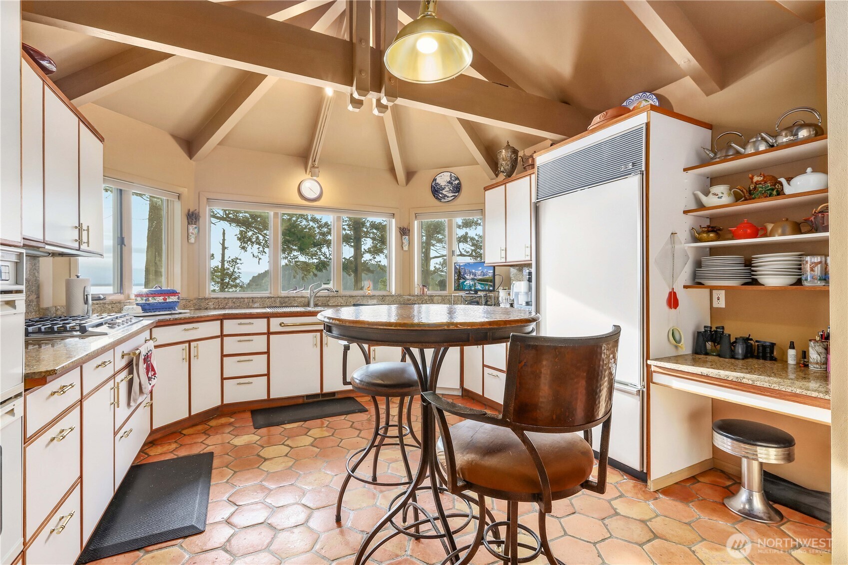 736 Tillamuk Drive La Conner, WA 98257 - Photo 11 of 34 a kitchen with a table chairs and a wooden floor