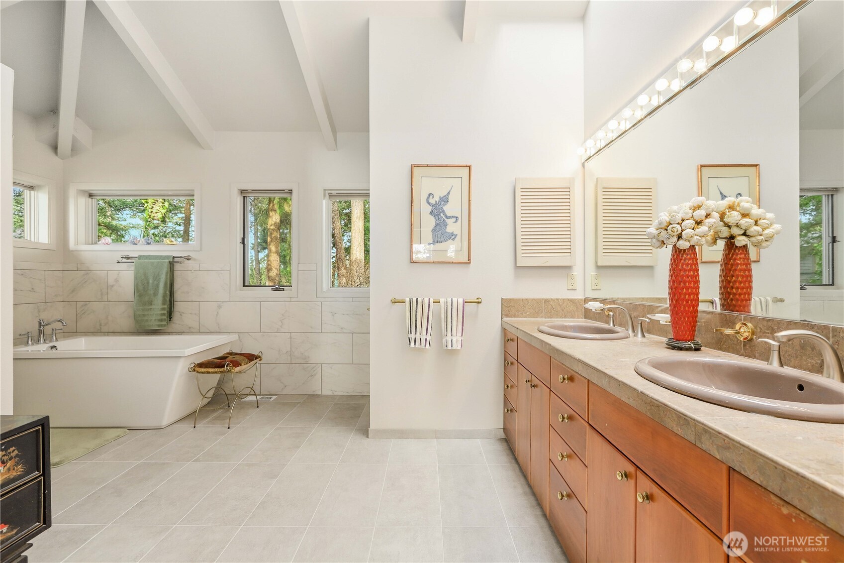 736 Tillamuk Drive La Conner, WA 98257 - Photo 16 of 34 a bathroom with a granite countertop double vanity sink a bathtub and next to a window