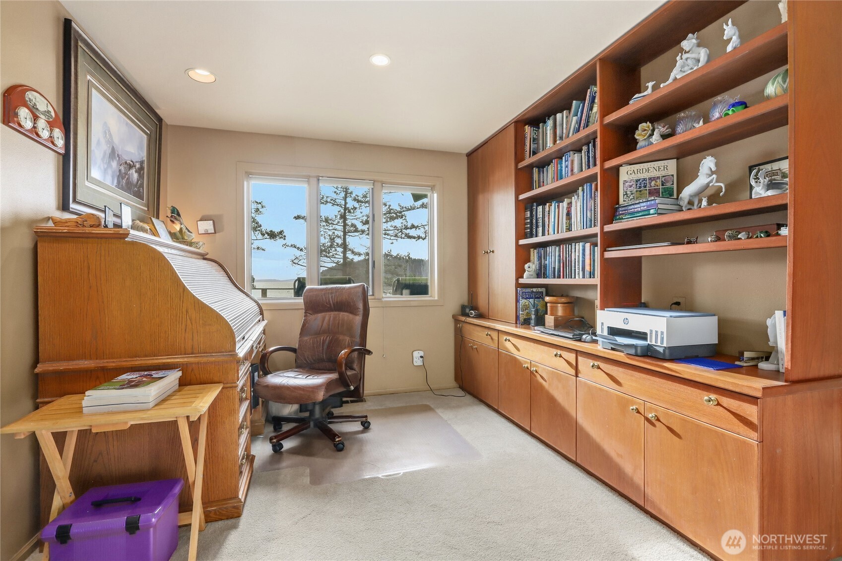 736 Tillamuk Drive La Conner, WA 98257 - Photo 22 of 34 a view of a workspace with furniture and a book shelf