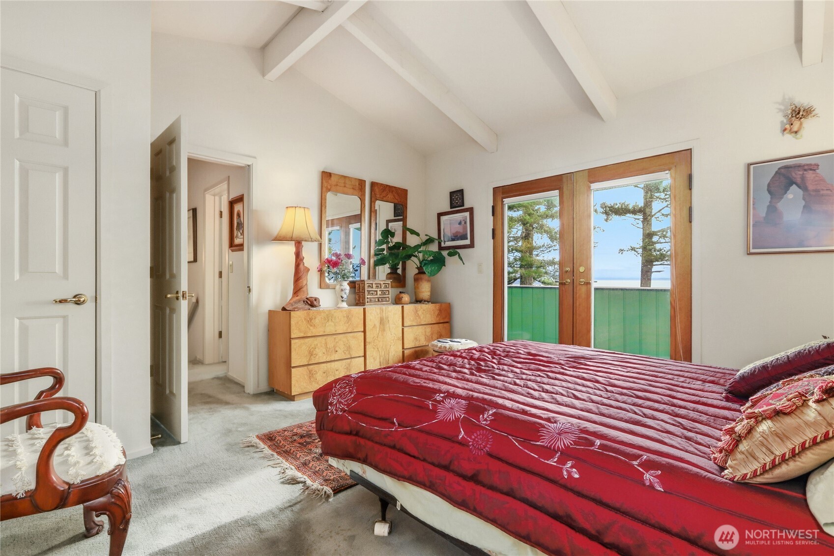 736 Tillamuk Drive La Conner, WA 98257 - Photo 29 of 34 a bedroom with a bed and large windows