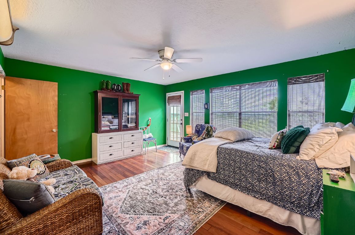 760 Skyline Ridge Lookout Wimberley, TX 78676 - Photo 21 of 40 Bedroom with hardwood / wood-style flooring and ceiling fan