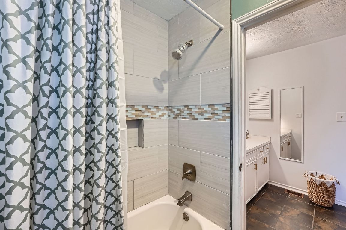 760 Skyline Ridge Lookout Wimberley, TX 78676 - Photo 28 of 40 Full bathroom with shower / bath combo with shower curtain, vanity, and a textured ceiling