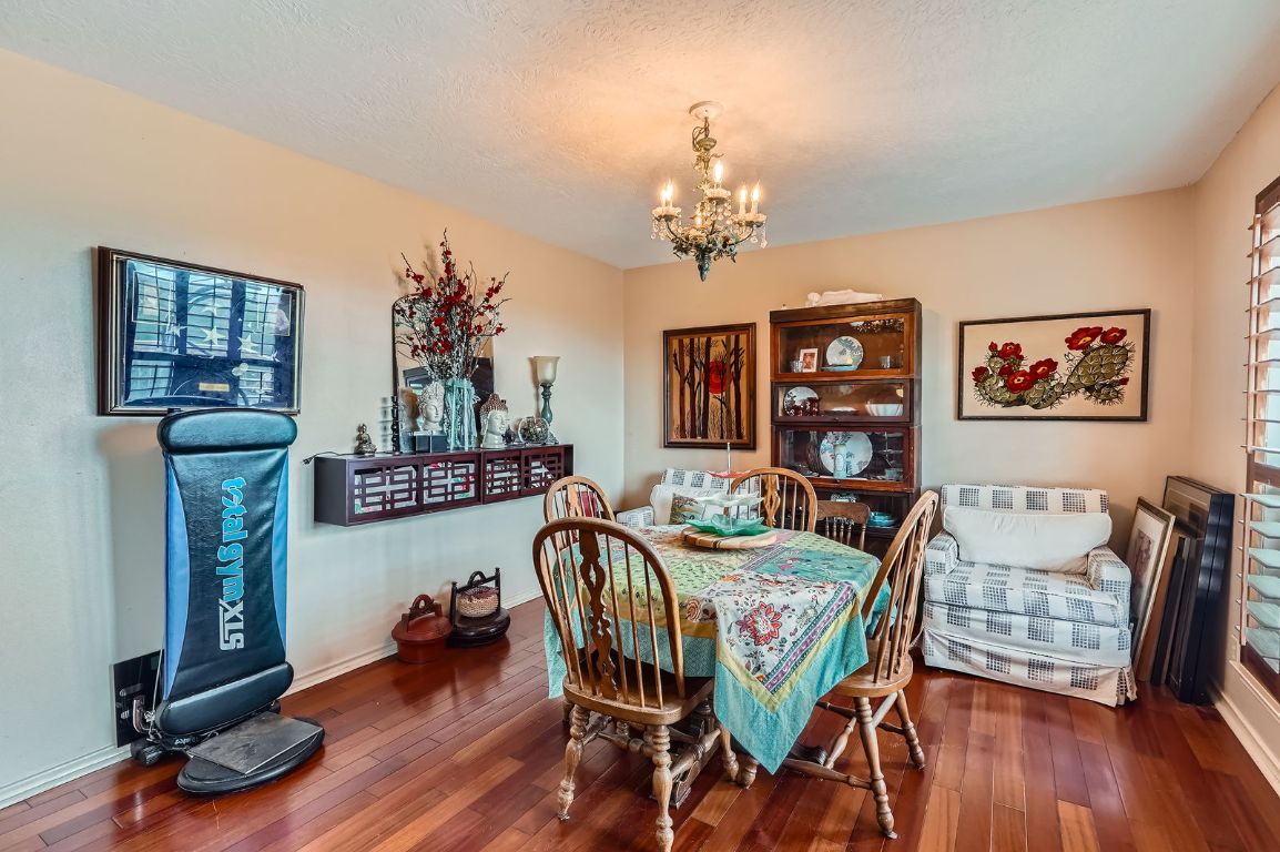 760 Skyline Ridge Lookout Wimberley, TX 78676 - Photo 8 of 40 Dining room with a chandelier and wood-type flooring