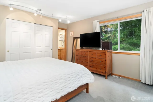 a bedroom with a bed and a flat screen tv