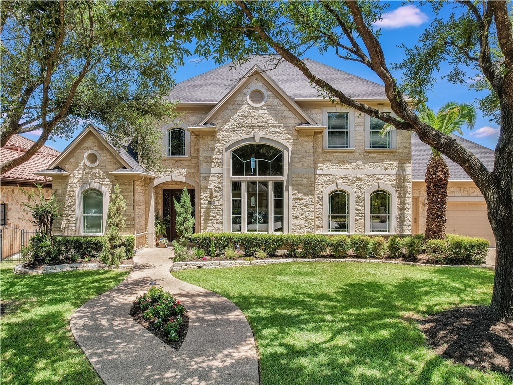 a front view of a house with a garden