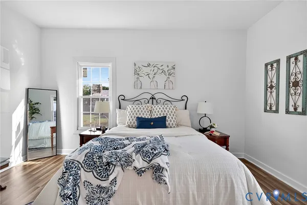 a bedroom with a bed and a painting on the wall