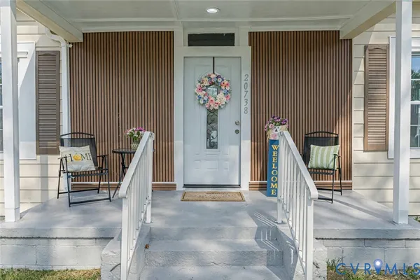 a view of a hallway to a livingroom and a dinning area with furniture