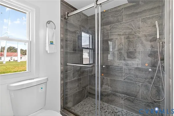 a bedroom with a bed and a potted plant