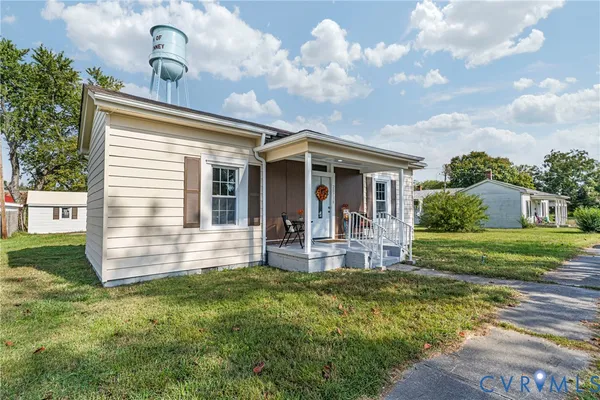 a front view of a house with yard and green space