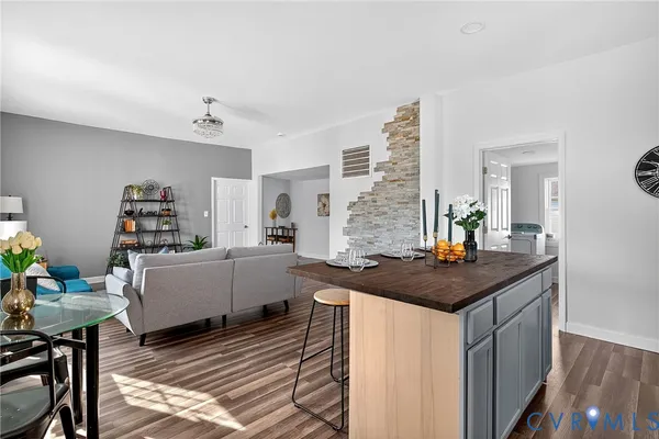 a living room with furniture and a book shelf