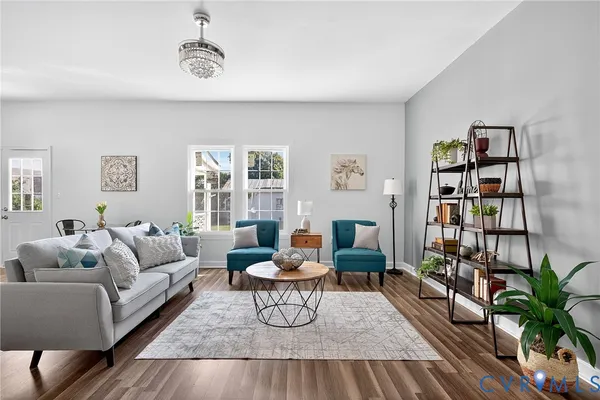 a living room with furniture and a wooden floor