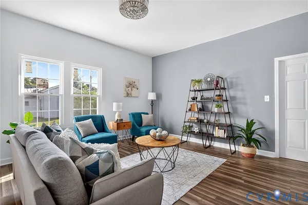 a living room with furniture and a wooden floor