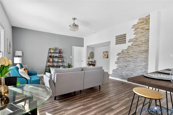 a living room with kitchen island granite countertop furniture and wooden floor